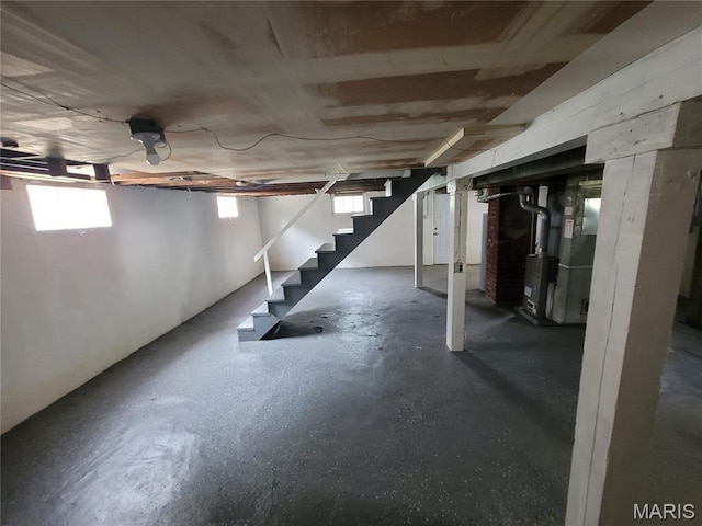 2965 Kincaid Ave, St John, MO 63114 - below grade area featuring stairway and heating unit