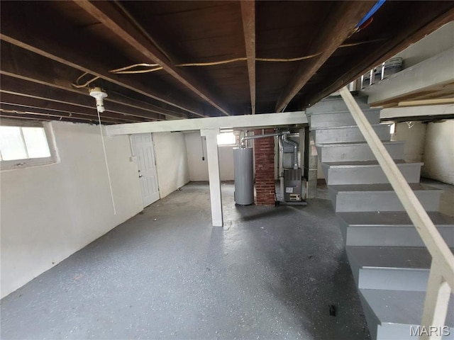 2965 Kincaid Ave, St John, MO 63114 - below grade area with water heater, heating unit, and stairs