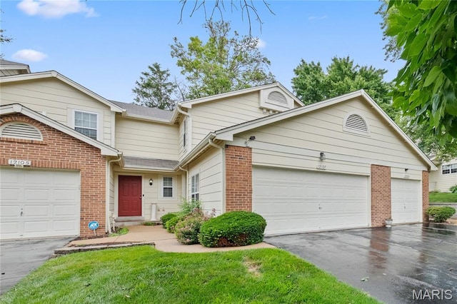 12107 Autumn Lakes Dr, Maryland Heights, MO 63043 - view of front of house featuring driveway, brick siding, an attached garage, and a front yard