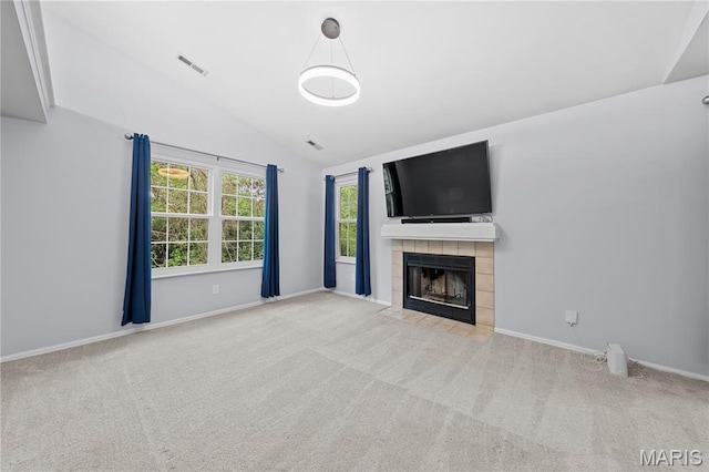 12107 Autumn Lakes Dr, Maryland Heights, MO 63043 - unfurnished living room with carpet floors, lofted ceiling, and a tile fireplace