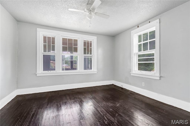 5746 Acme, Jennings, MO 63136 - empty room with healthy amount of natural light, dark wood finished floors, a textured ceiling, and ceiling fan