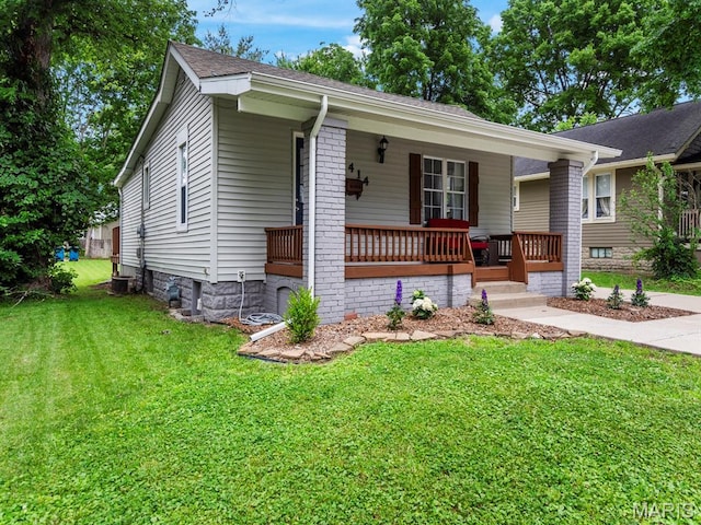 414 Plum St, Edwardsville, IL 62025 - ranch-style home featuring covered porch, a front yard, and roof with shingles