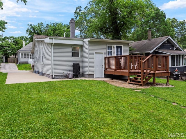 414 Plum St, Edwardsville, IL 62025 - back of property with a deck, a chimney, a yard, and a patio area