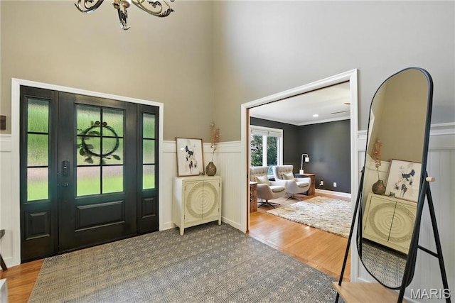 3 Morganfield Ct, Chesterfield, MO 63005 - foyer entrance with a towering ceiling, wood finished floors, a chandelier, wainscoting, and a decorative wall
