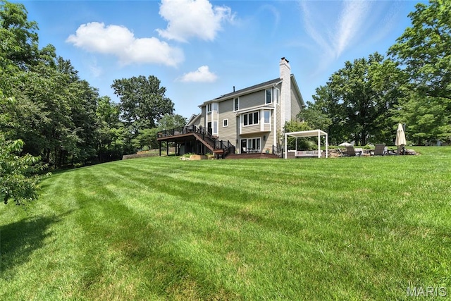 3 Morganfield Ct, Chesterfield, MO 63005 - back of property with a deck, stairs, a yard, and a chimney