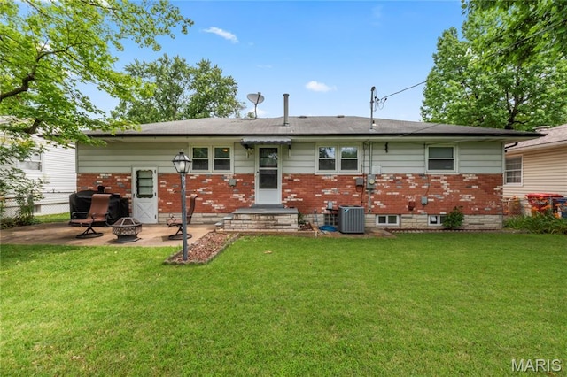 1140 Lindsay Ln, Florissant, MO 63031 - rear view of property featuring a fire pit, brick siding, and a patio