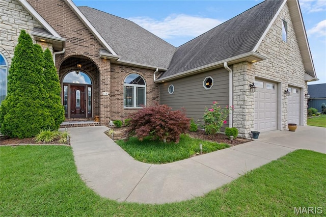 108 Jennings Ln, Sikeston, MO 63801 - view of front of property with roof with shingles, concrete driveway, a front lawn, and stone siding