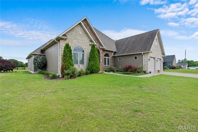 108 Jennings Ln, Sikeston, MO 63801 - view of property exterior with stone siding, a yard, a garage, concrete driveway, and a shingled roof