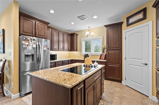 108 Jennings Ln, Sikeston, MO 63801 - kitchen featuring black appliances, light stone countertops, a center island, dark brown cabinetry, and recessed lighting