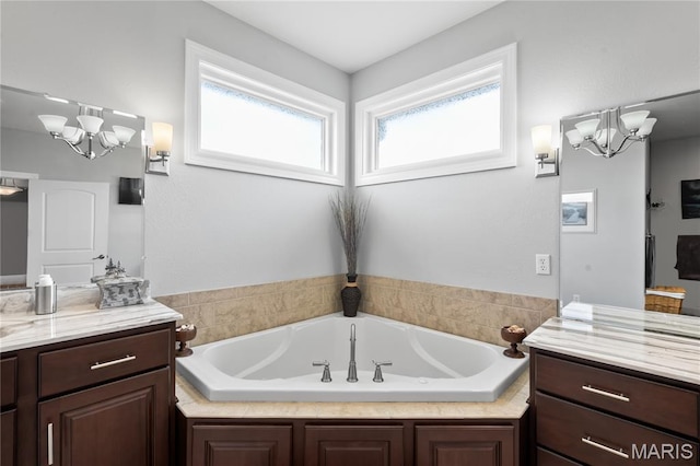 108 Jennings Ln, Sikeston, MO 63801 - bathroom featuring a chandelier, vanity, and a bath