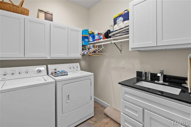 108 Jennings Ln, Sikeston, MO 63801 - washroom featuring washing machine and dryer, cabinet space, and light tile patterned floors