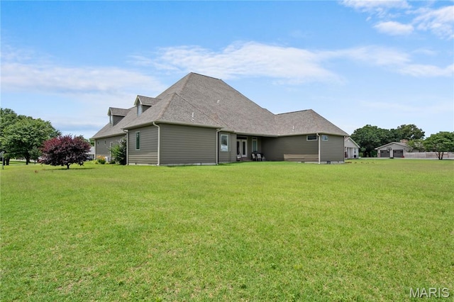 108 Jennings Ln, Sikeston, MO 63801 - rear view of house featuring a lawn and roof with shingles