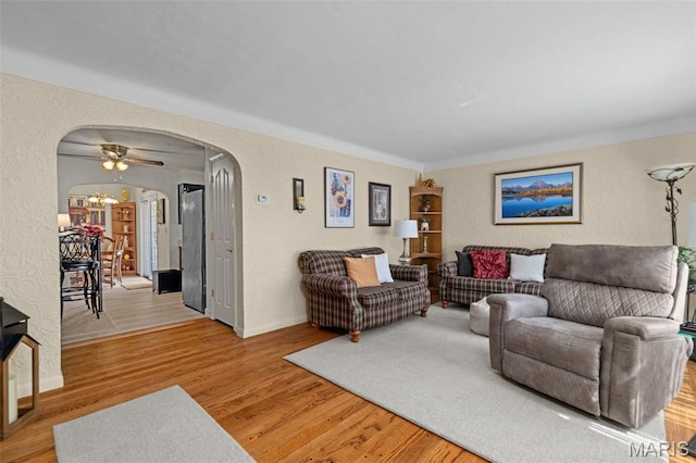 111 Freedom Dr, Belleville, IL 62226 - living area with a textured wall, arched walkways, light wood finished floors, and a chandelier