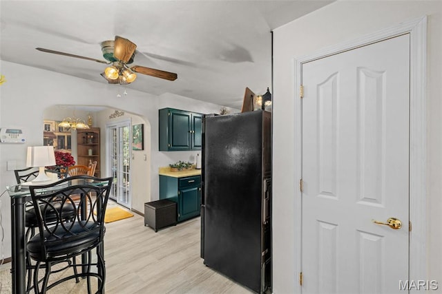 111 Freedom Dr, Belleville, IL 62226 - kitchen featuring freestanding refrigerator, a ceiling fan, arched walkways, light wood-style floors, and light countertops