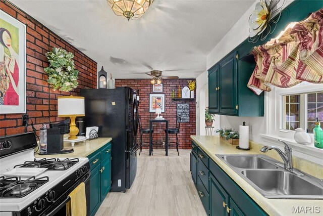 111 Freedom Dr, Belleville, IL 62226 - kitchen with gas range, brick wall, ceiling fan, and light countertops