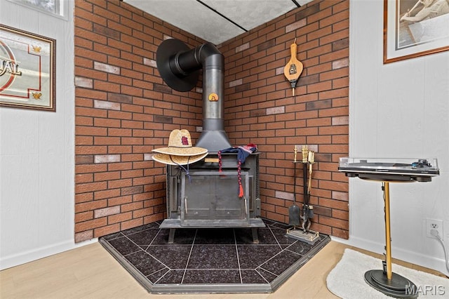111 Freedom Dr, Belleville, IL 62226 - detailed view of a wood stove, brick wall, and wood finished floors