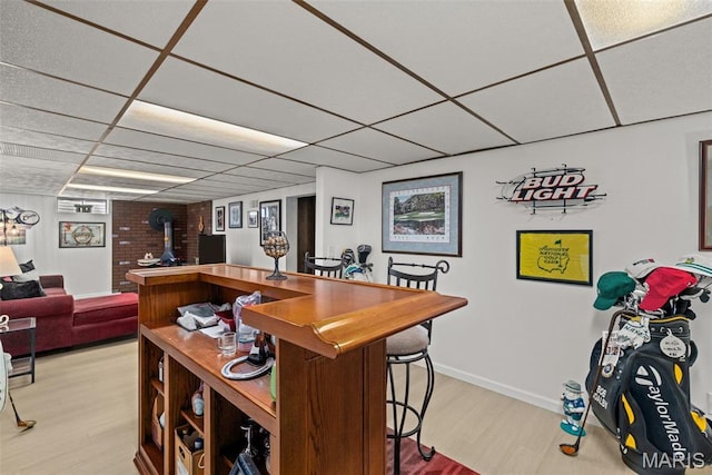 111 Freedom Dr, Belleville, IL 62226 - bar area with a drop ceiling, light wood-type flooring, and a wood stove