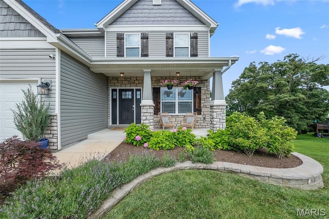 5107 Ruddy Ridge Ct, High Ridge, MO 63049 - view of front of house with a porch, stone siding, a garage, and a front lawn