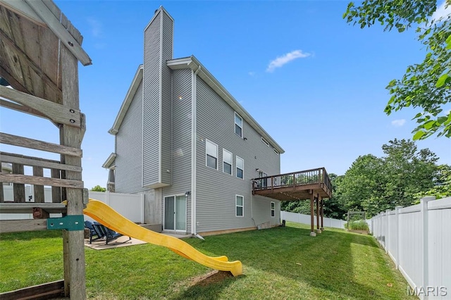 5107 Ruddy Ridge Ct, High Ridge, MO 63049 - back of property featuring a chimney, a fenced backyard, a wooden deck, and a playground