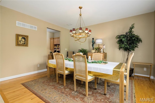 1001 Laurel Bend Ct S, Kirkwood, MO 63122 - dining space with a chandelier and light wood-type flooring