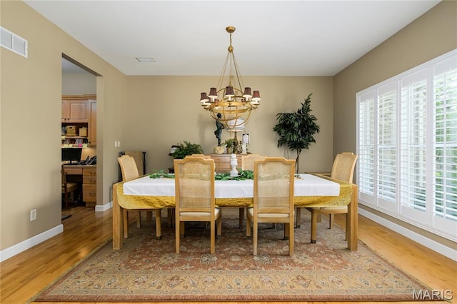 1001 Laurel Bend Ct S, Kirkwood, MO 63122 - dining area with a chandelier, light wood finished floors, and plenty of natural light