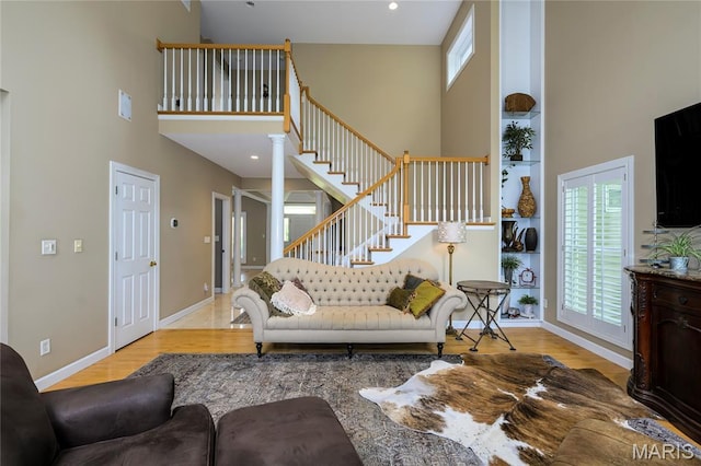 1001 Laurel Bend Ct S, Kirkwood, MO 63122 - living area featuring a high ceiling, wood finished floors, stairs, and recessed lighting