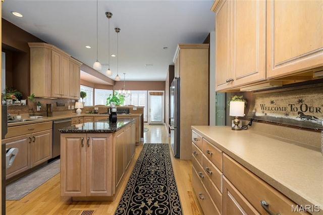 1001 Laurel Bend Ct S, Kirkwood, MO 63122 - kitchen featuring appliances with stainless steel finishes, light wood finished floors, light brown cabinets, decorative backsplash, and recessed lighting
