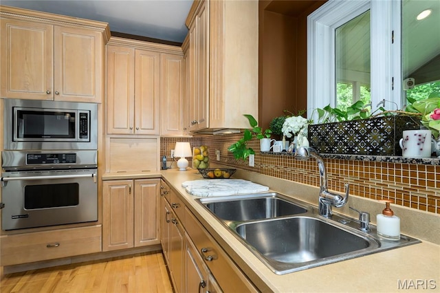 1001 Laurel Bend Ct S, Kirkwood, MO 63122 - kitchen featuring appliances with stainless steel finishes, light countertops, decorative backsplash, and light brown cabinetry