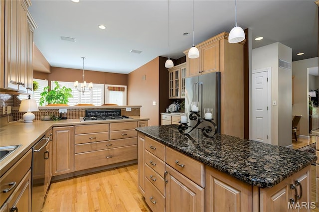 1001 Laurel Bend Ct S, Kirkwood, MO 63122 - kitchen featuring stainless steel appliances, light wood finished floors, a chandelier, backsplash, and glass insert cabinets