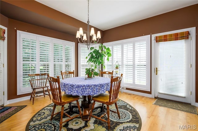 1001 Laurel Bend Ct S, Kirkwood, MO 63122 - dining space with light wood-style flooring and a chandelier