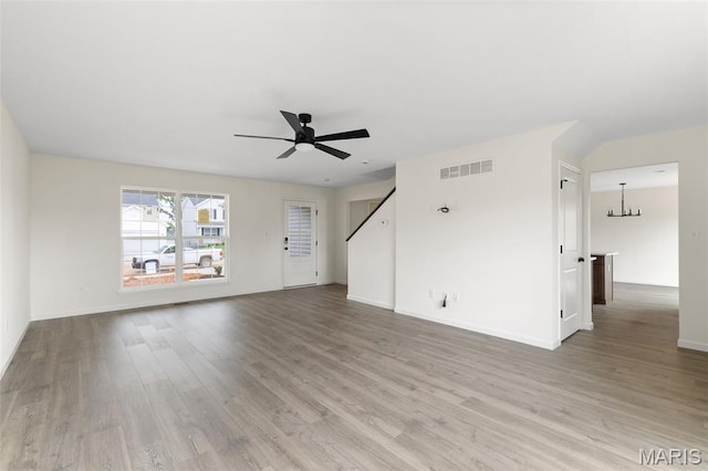 510 Founders Way, Foristell, MO 63348 - unfurnished living room featuring a ceiling fan, light wood finished floors, and a chandelier