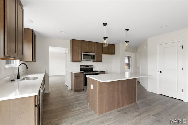 510 Founders Way, Foristell, MO 63348 - kitchen with stainless steel appliances, light wood finished floors, light countertops, a kitchen island, and recessed lighting
