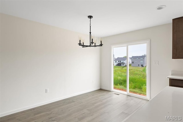 510 Founders Way, Foristell, MO 63348 - unfurnished dining area with a chandelier and light wood finished floors