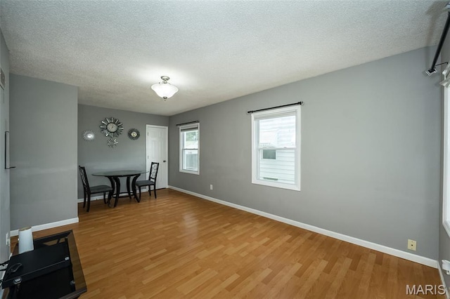 4322 Heidelberg Ave, Saint Louis, MO 63123 - dining space featuring light wood-type flooring and a textured ceiling