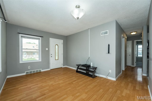 4322 Heidelberg Ave, Saint Louis, MO 63123 - entrance foyer featuring light wood finished floors and a textured ceiling