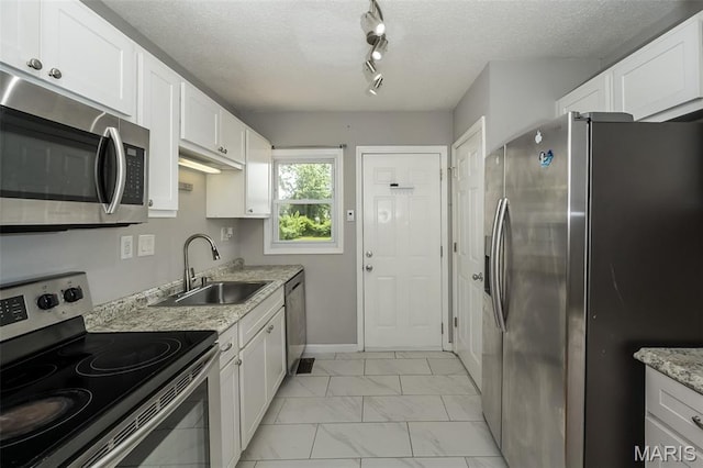 4322 Heidelberg Ave, Saint Louis, MO 63123 - kitchen with stainless steel appliances, light marble finish floors, white cabinets, a textured ceiling, and light stone counters