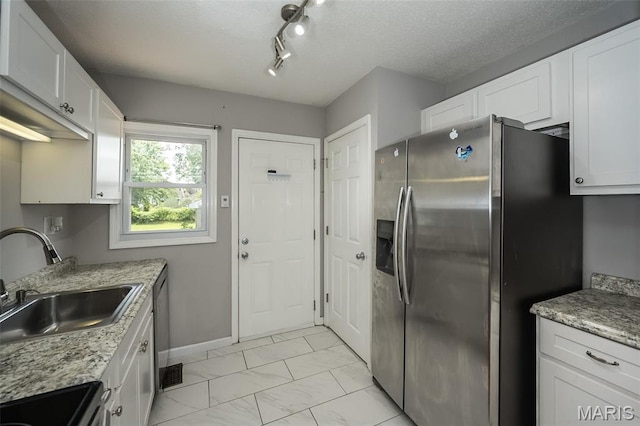 4322 Heidelberg Ave, Saint Louis, MO 63123 - kitchen with stainless steel appliances, light marble finish flooring, white cabinetry, light stone counters, and a textured ceiling