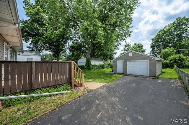 4322 Heidelberg Ave, Saint Louis, MO 63123 - view of yard featuring a garage, driveway, and an outdoor structure