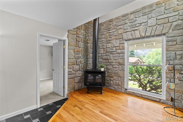 404 Applestone Dr, Ballwin, MO 63021 - unfurnished living room featuring a wood stove and baseboards