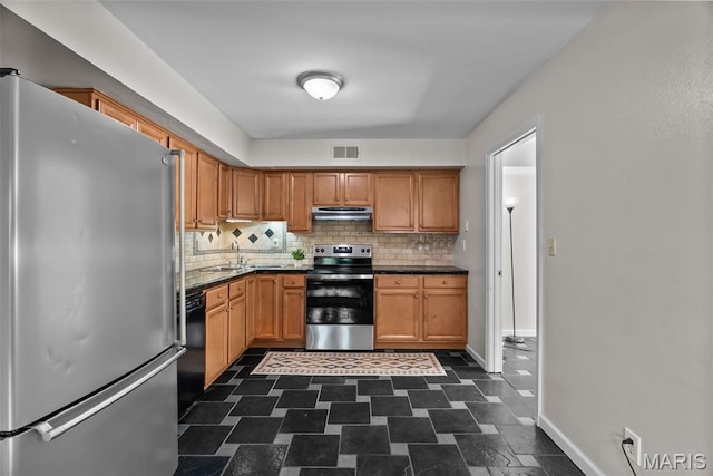 404 Applestone Dr, Ballwin, MO 63021 - kitchen with stainless steel appliances, backsplash, under cabinet range hood, dark countertops, and brown cabinets