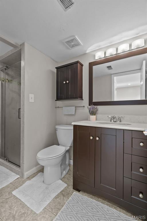 404 Applestone Dr, Ballwin, MO 63021 - bathroom featuring vanity, a shower stall, and tile patterned floors