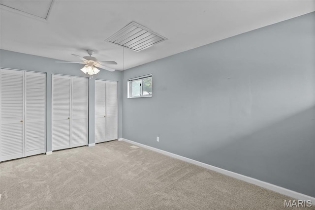 404 Applestone Dr, Ballwin, MO 63021 - unfurnished bedroom featuring two closets, carpet flooring, and a ceiling fan