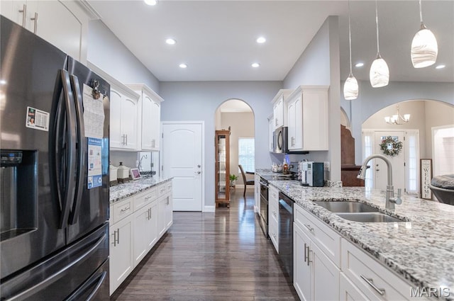 12200 Country Oaks Dr, Rolla, MO 65401 - kitchen with stainless steel appliances, arched walkways, white cabinets, light stone counters, and recessed lighting