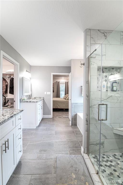 12200 Country Oaks Dr, Rolla, MO 65401 - full bathroom featuring vanity, a marble finish shower, a bath, connected bathroom, and a spacious closet