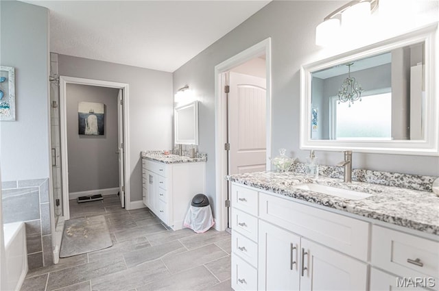 12200 Country Oaks Dr, Rolla, MO 65401 - full bath featuring two vanities, a garden tub, a chandelier, and a stall shower