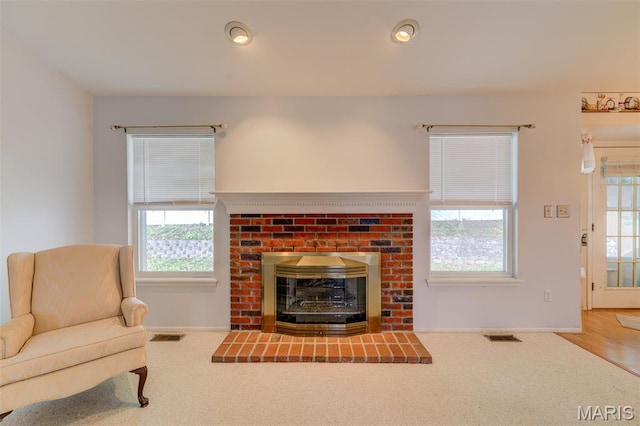 1733 Forest Trace Dr, Ofallon, MO 63368 - carpeted living room with a brick fireplace, healthy amount of natural light, and recessed lighting