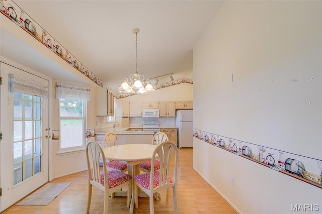 1733 Forest Trace Dr, Ofallon, MO 63368 - dining area with a chandelier and light wood-type flooring