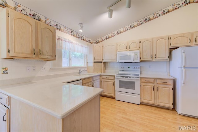 1733 Forest Trace Dr, Ofallon, MO 63368 - kitchen featuring white appliances, light brown cabinetry, light countertops, a peninsula, and lofted ceiling