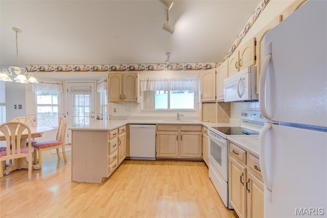 1733 Forest Trace Dr, Ofallon, MO 63368 - kitchen with white appliances, light brown cabinets, a peninsula, a chandelier, and light wood-type flooring
