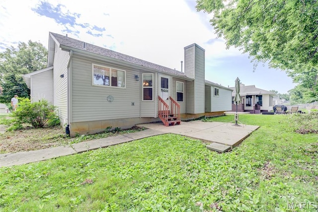 1733 Forest Trace Dr, Ofallon, MO 63368 - rear view of property featuring entry steps, a chimney, a patio area, and a lawn